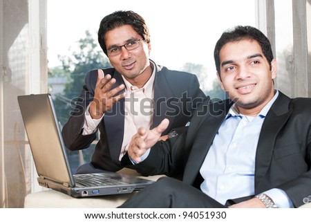two Indian businessmen in meeting, two businessmen working on the laptop