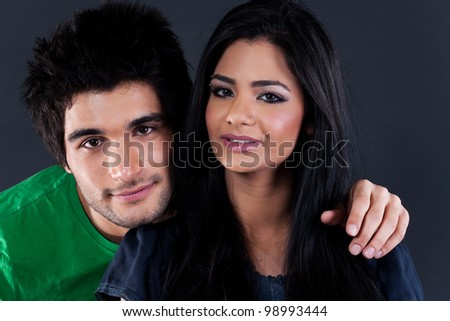 portrait of ethnic couple couple in studio, latin american man with Indian girl