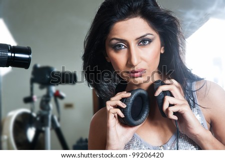 girl listening music on head phones, lights camera action
