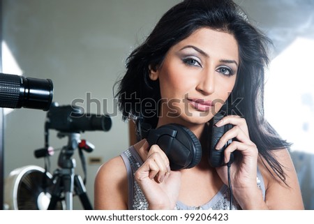 girl listening music on head phones, lights camera action