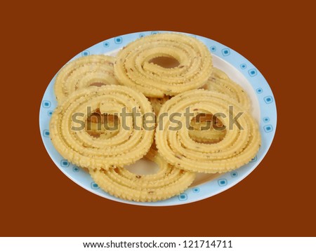 Snack made from a lentil flour dough, which is pressed into a specific shape with a hand mill and then the shape is deep fried in oil.