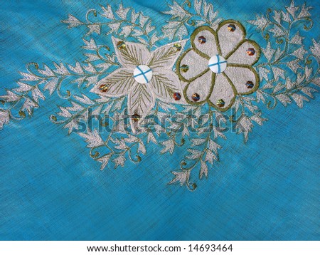 Closeup of a beautiful flower and leaves pattern embroidery.