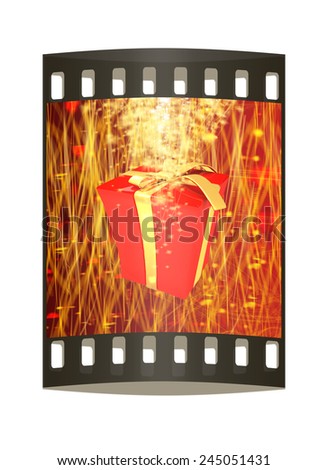 red gift box with golden ribbon on fantastic background with a wave of stars. The film strip