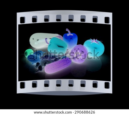 fresh vegetables with leaves on a black background. The film strip