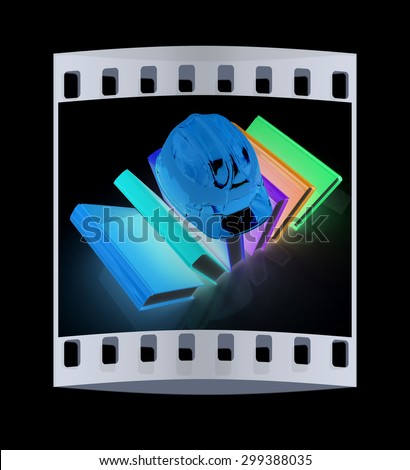 Colorful books and hard hat on a black background. The film strip