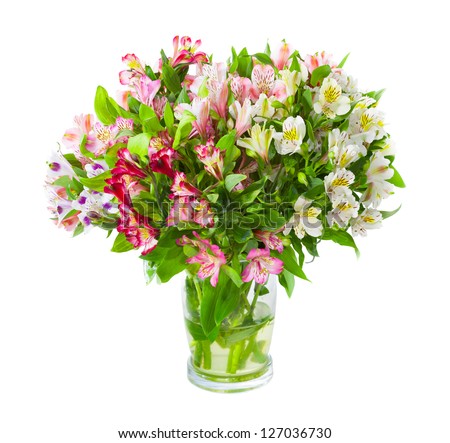 Bouquet of alstroemeria flowers in glass vase isolated over white background