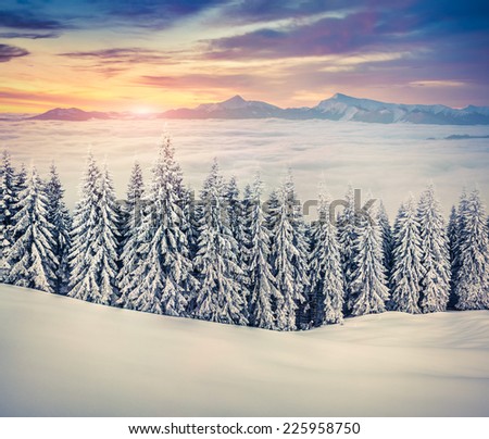 Beautiful winter sunrise in the; foggy mountains. Retro style.