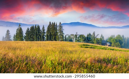 Colorful summer sunrise in Carpathian mountain village.