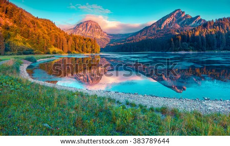 Colorful summer sunrise on the incredibly beautiful Swiss lake Obersee, located near Nafels village. Alps, Switzerland, Europe. Instagram toning.