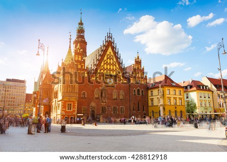 Colorful morning scene on Wroclaw Market Square with Town Hall. Sunny cityscape in historical capital of Silesia, Poland, Europe. Artistic style post processed photo.