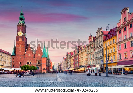 Colorful evening scene on Wroclaw Market Square with Town Hall. Sunset in historical capital of Silesia, Poland, Europe. Artistic style post processed photo.