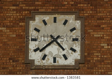 Old clock mounted on the face of a building.