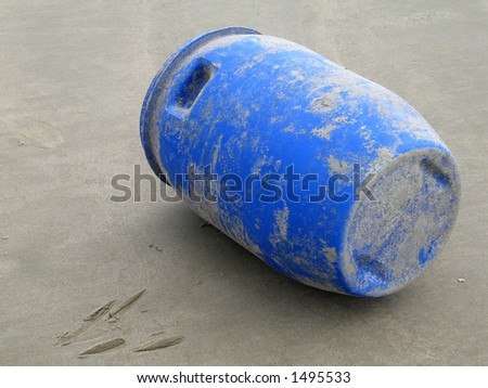Blue plastic barrel on beach