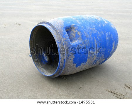 Blue plastic barrel on beach
