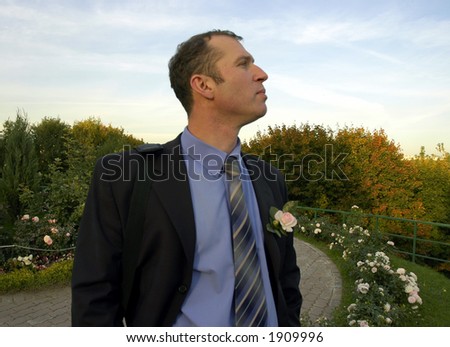Man with rose on suit