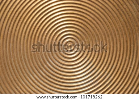 Abstract circle metal plate- golden surface with round lines.