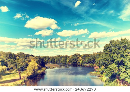 Landscape with river, forest, blue sky and clouds. Ukraine. Instagram colors.