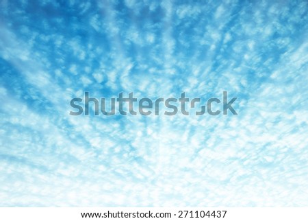 Bright sun shining on blue sky and texture of white clouds