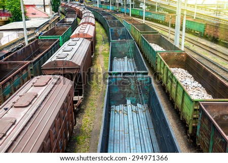 Many trains with cargo wagons on the railroad