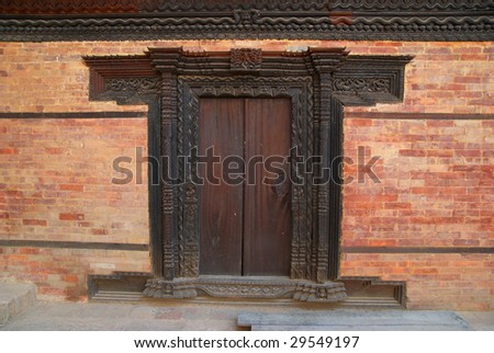 Old wooden door of buddhistic house. Baktaphur, Nepal