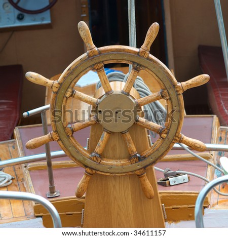 Old wooden steering wheel on the boat