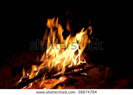 Red bright campfire with the black background