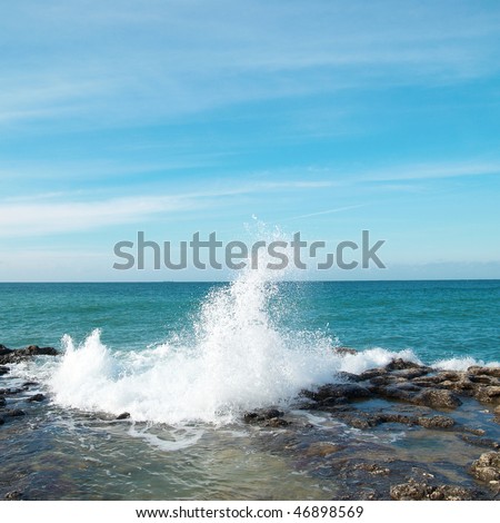 Big waves breaking on the shore with sea foam