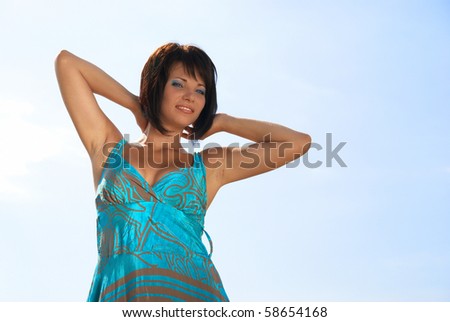 Woman in dress on the blue sky background