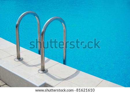 Swimming pool with stair and blue relaxing water