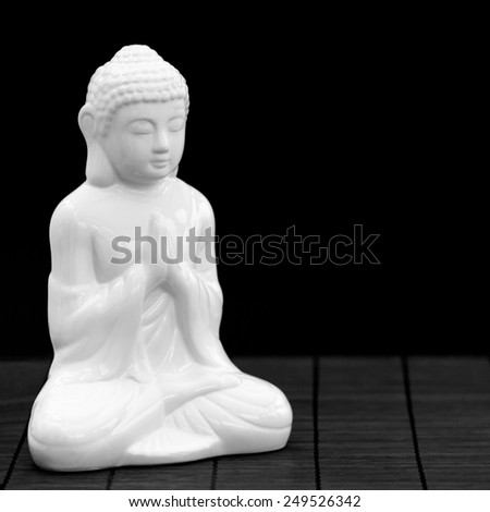 Square shot of a white figure in meditation pose