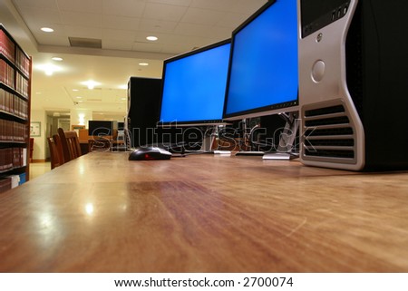 a computer with two monitors; the monitors are turned on