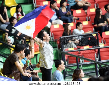 BANGKOK - FEB13:Fan of San Miguel Beermen team waving flag of Philippines in an ASEAN Basketball League \