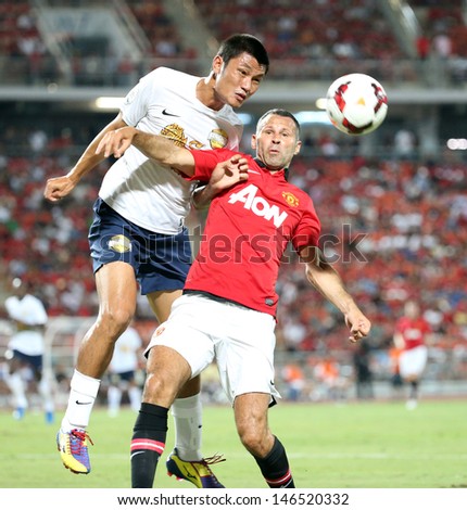 BANGKOK - JULY 13:Ryan Giggs (R) of Man Utd. fight for the ball during Singha 80th Anniversary Cup Manchester United vs Singha All Star at Rajamangala Stadium on July 13,2013 in Bangkok, Thailand.