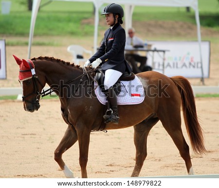 CHONBURI, THAILAND - JULY 26:Pingkan Motira of Indonesia with Fluck in action during 1st FEI Asian Eventing Championships 2013 at Thai Polo&Equestrian Club on July 26, 2013 in Chonburi, Thailand.