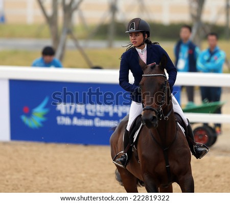INCHEON - SEP 28:CHEW Yen Tung Catherine Marissa of Singapore in action during the 2014 Incheon Asian Games at Dream Park Equestrian Venue on September 28, 2014 in Incheon, South Korea.