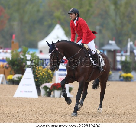 INCHEON - SEP 28:HUANG Po Hsiang of Chinese Taipai in action during the 2014 Incheon Asian Games at Dream Park Equestrian Venue on September 28, 2014 in Incheon, South Korea.