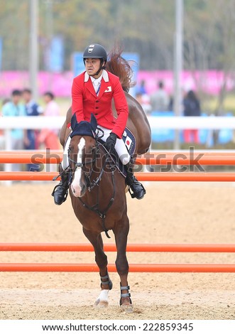 INCHEON - SEP 28:UTSUNOMIYA Takashi of Japan  in action during the 2014 Incheon Asian Games at Dream Park Equestrian Venue on September 28, 2014 in Incheon, South Korea.