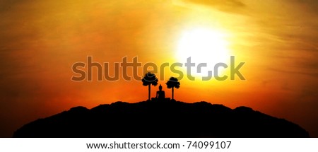 Buddha silhouette  on mountain with sunset background