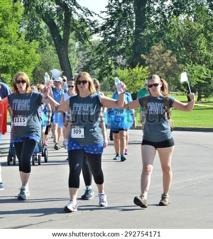 Denver, CO, USA  06/27/2015 Women waving at the Denver Colon Cancer Undy Run/Walk! The Undy Run/Walk is a family-friendly fundraising event that was created by the Colon Cancer Alliance.