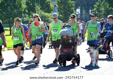 Denver, CO, USA  06/27/2015 Team walking together at the Denver Colon Cancer Undy Run/Walk! The Undy Run/Walk is a family-friendly fundraising event that was created by the Colon Cancer Alliance.