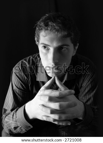 Pensive man over black background. Black&white.