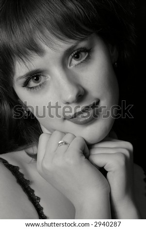 Close-up loving girl  over black background. black&white