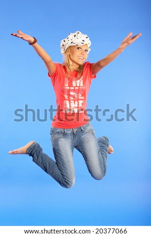 happiness girl jumps on a blue background