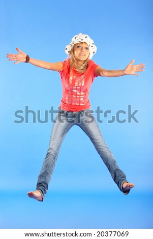 young girl jumps on a sky blue background