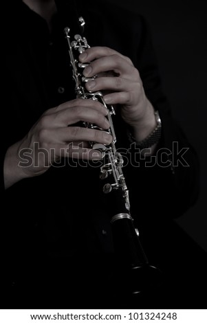 Clarinet player in front of black background