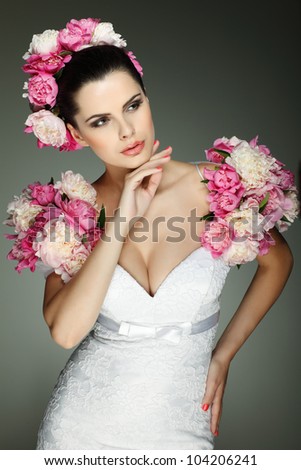 An elegant sexual brunette is in a wedding-dress, decorated pink colors