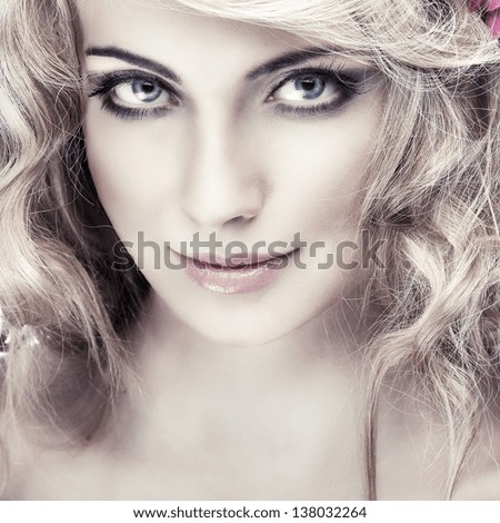 Closeup portrait of sexy whiteheaded young woman with beautiful blue eyes on light - grey background - stock photo