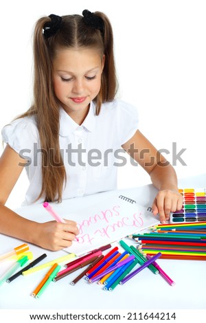 A beautiful girl in a school form drawing a marker, isolated on a white background