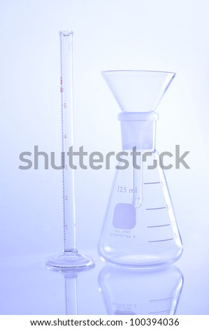 Elemeyer flask with glass funnel for chemical science use in laboratory.