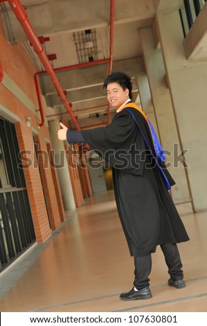 Fashion of graduate in thailand ,graduation boy holding his master\'s degree.And business action.